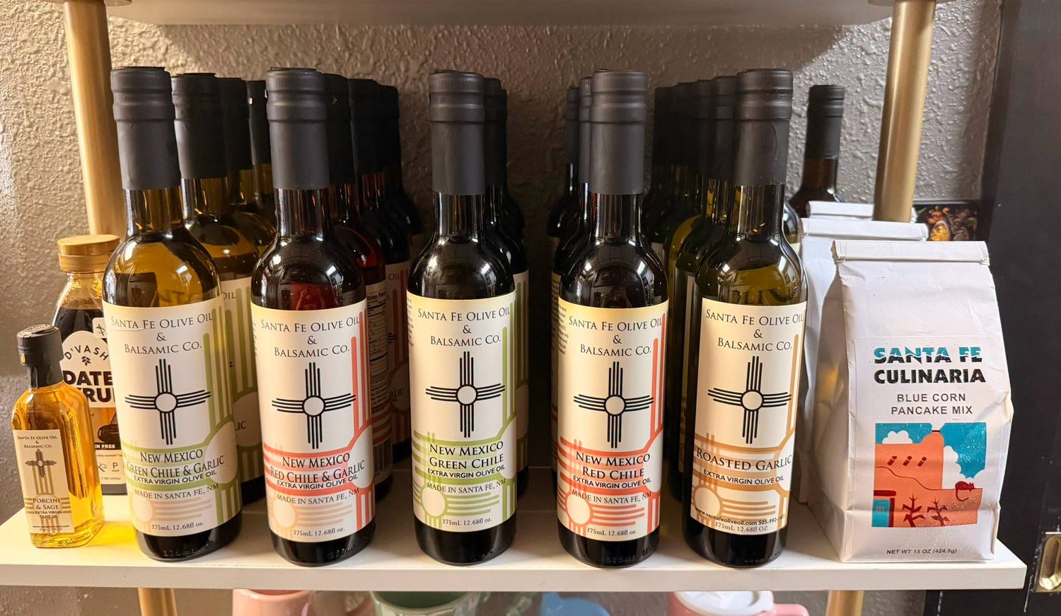 Bottles of Santa Fe Olive Oil & Balsamic Co. chile-infused olive oils and blue corn pancake mix